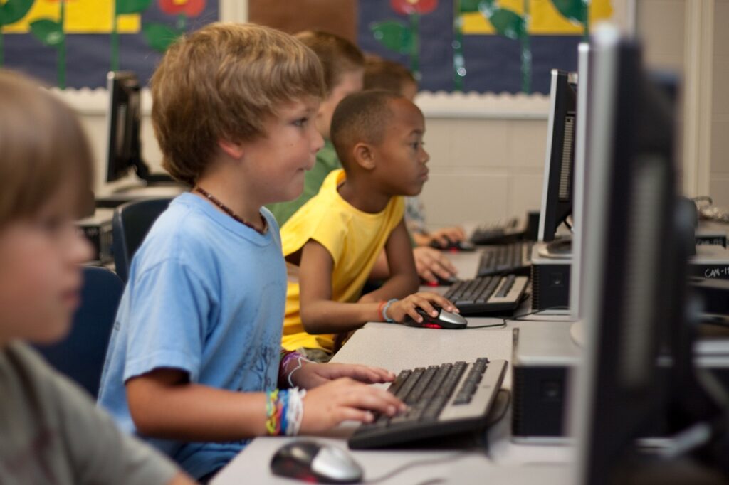 Elementary school aged children logged on computers